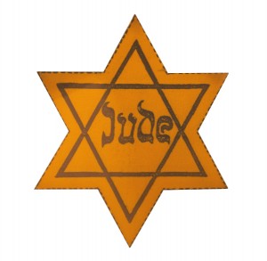 A yellow star, like those worn by Jewish people during WWII in Germany and wider Europe, to make them easily identifiable